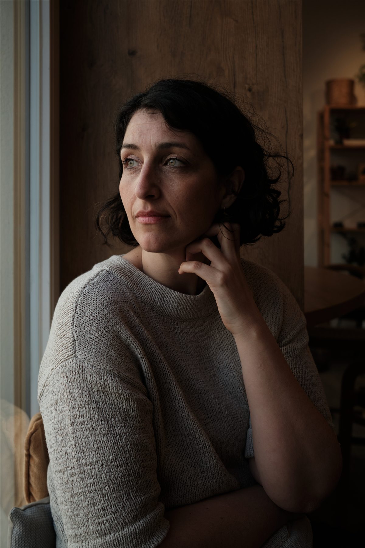 Natural-light portrait of a young professional in Berlin by a window