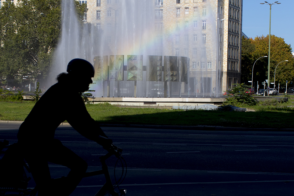 Berlin street photo of a Beautiful rainbow from a fountain 